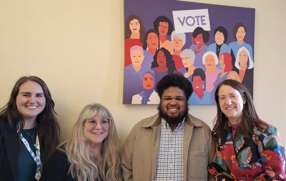 Northwest Center Employees and lawmakers standing in front of an image reading VOTE