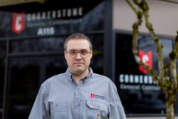 Cornerstone employee standing in front of a building.