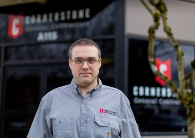 Cornerstone employee standing in front of a building.
