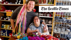 Two people smiling at a knitting yarn supplier. The Seattle Times.