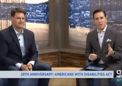 Two men sitting in a studio. 29th anniversary: Americans with Disabilities Act on Q13 News.